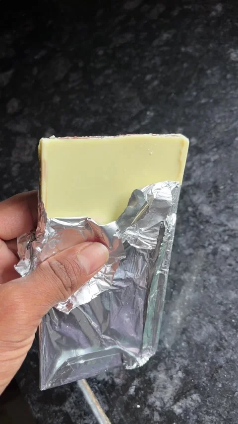 White Milk Chocolate Held in Hand Close-Up 4K Video Stock-Footage 322901418