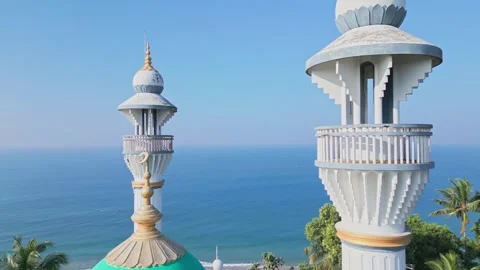 White Minarets Mosque stand against the backdrop of the Indian Ocean at dawn Stock Footage 281847604
