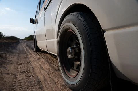 White Mini-bus Van on Dirt Road Foto stock