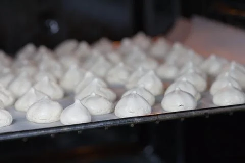 White mini meringue in baking sheet Stock Photos
