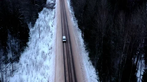 White minibus on the forest winter road 動画素材 146401899