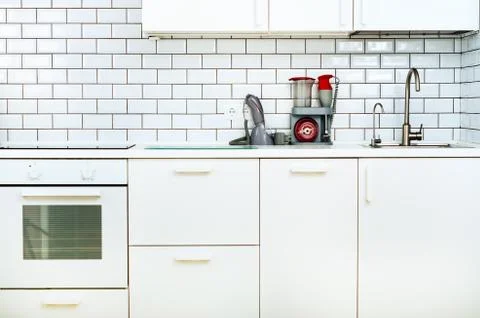 White minimalistic kitchen interior and design. Tile wall background. Household Stock Photos