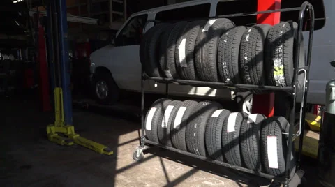 White minivan behind the tires Stock Footage 35089805