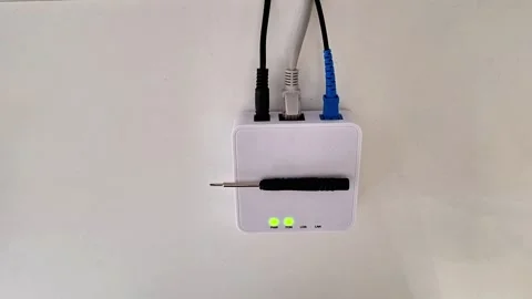 White Modem Electronic Device with Cables and Green Indicator Lights on Wall 動画素材 333230059