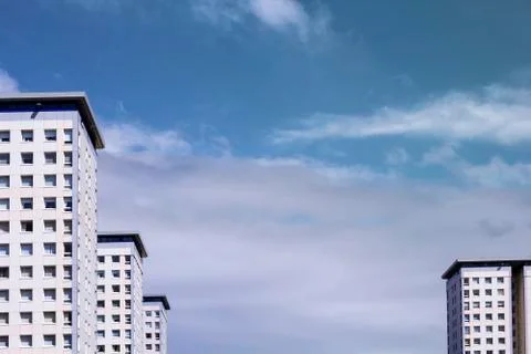 White, modern blocks of flats and blue sky, modern background Stock Photos
