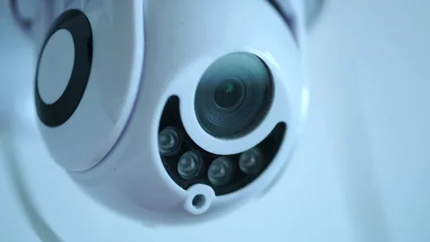 White Modern CCTV Camera Rotates And Surveys Area, 4K Security System Stock Footage 129877342