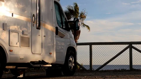 White modern empty camper parked on a parking overlooking a beach Stock Footage 119077831