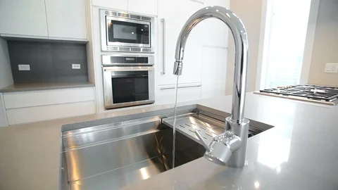 White modern kitchen in a house with a beautiful design Stock Footage 101858008