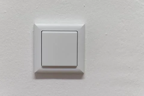 White modern light switch on textured wall Stock Photos