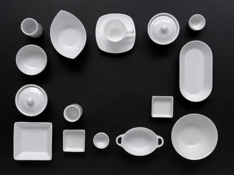 White, modern tableware on a black background Stock Photos