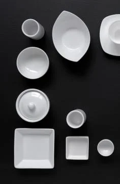 White, modern tableware on a black background Foto stock