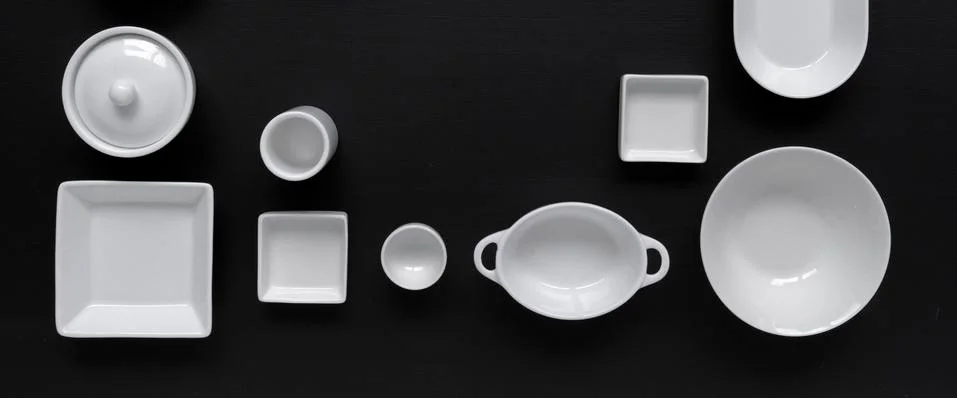 White, modern tableware on a black background Foto stock
