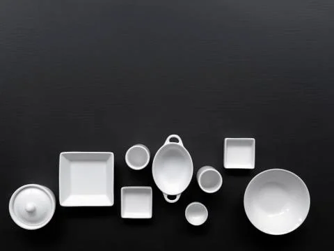 White, modern tableware on a black background Fotos de archivo