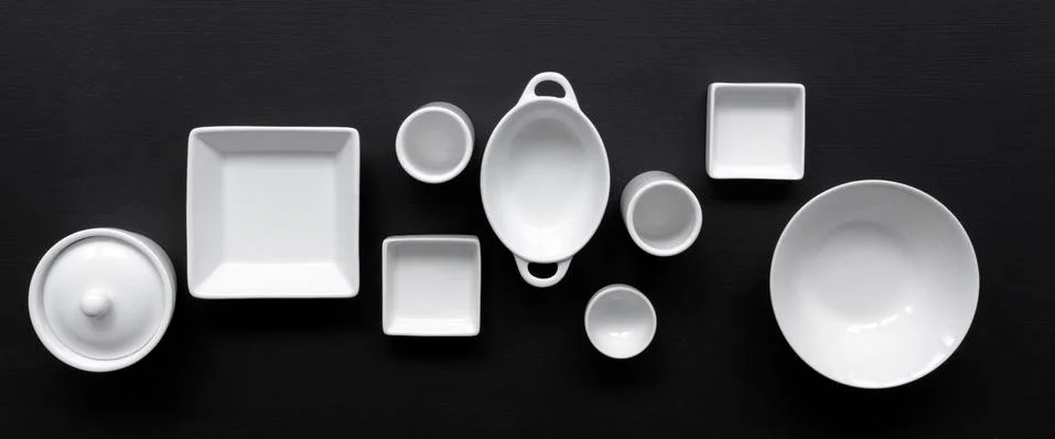 White, modern tableware on a black background Foto stock