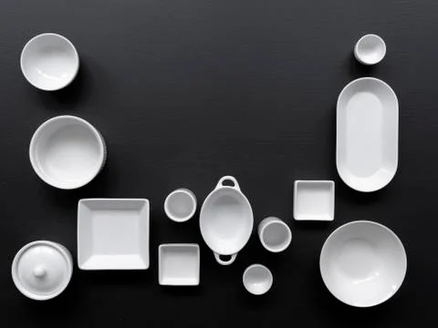 White, modern tableware on a black background Stock Photos