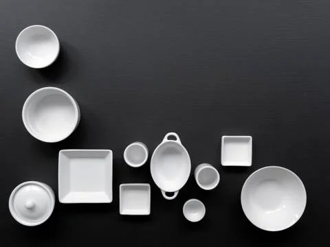 White, modern tableware on a black background Stock Photos
