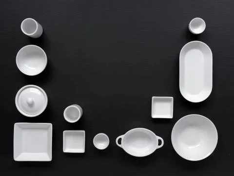 White, modern tableware on a black background Foto stock