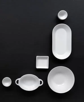 White, modern tableware on a black background Foto stock