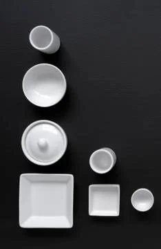 White, modern tableware on a black background Foto stock
