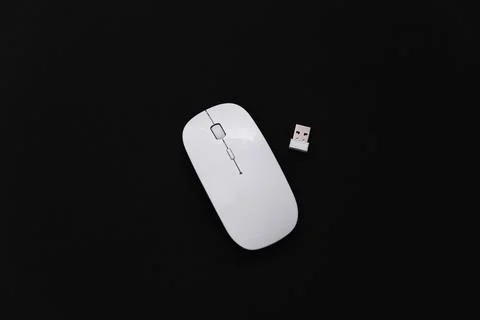 White modern wireless pc mouse on black background. Top view Stock Photos
