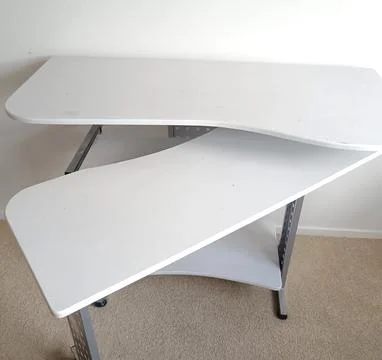 White modular computer desk with multiple shelves, metal supports, Stock Photos