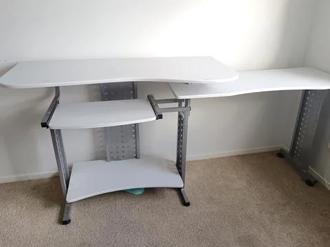 White modular computer desk with multiple shelves, metal supports, Stock Photos