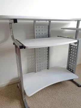 White modular computer desk with multiple shelves, metal supports, Stock Photos