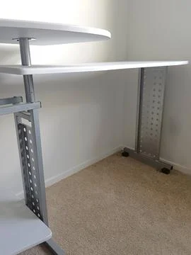 White modular computer desk with multiple shelves, metal supports, Stock Photos