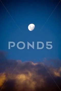 White moon and dusk clouds Stock Photos