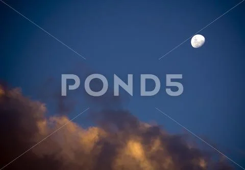 White moon and dusk clouds Stock Photos