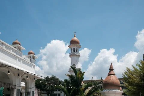 White mosque with red domes and minaret Stock Photos