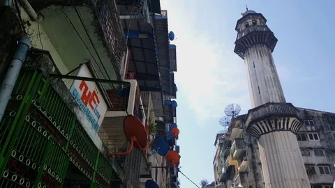 White mosque tower in Yangon, satellite dishes on buildings, pigeons fly, sky Vídeos de archivo 77814153