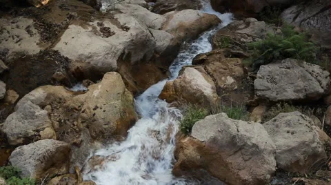 White mountain stream water, flowing through the stones Stock Footage 62981294