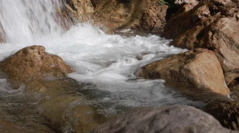 White mountain stream water, flowing through the stones Stock Footage 62981320