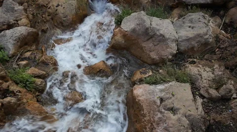 White mountain stream water, flowing through the stones Stock Footage 62981720