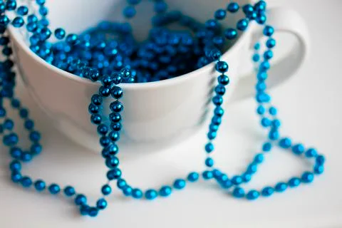 The white mug with blue beads Stock Photos