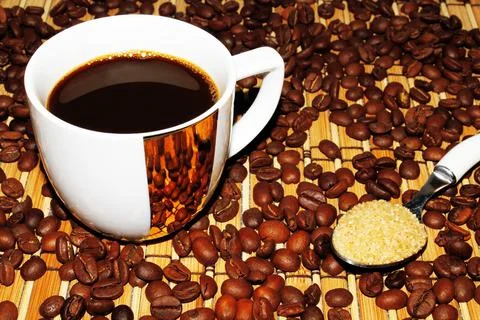 White mug with coffee on the background of beans and mats 写真素材