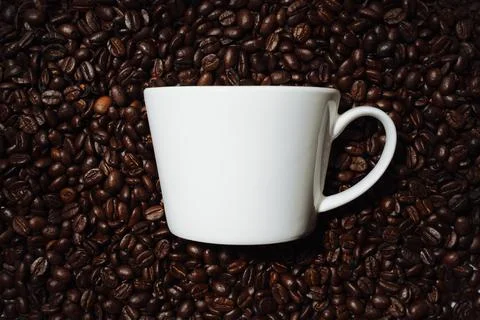 White mug on coffee beans Stock Photos