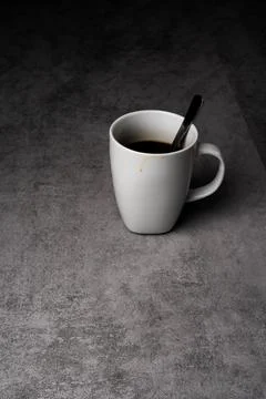 White Mug with Coffee on Gray Surface Stock-Fotos