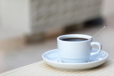 White mug of coffee on the table Stock Photos