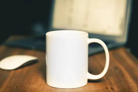 White mug on the desktop Stock Photos