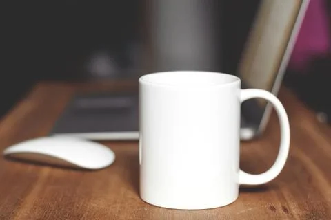 White mug on the desktop Stock Photos