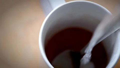 White mug filled with fresh coffee on a table. Stock Footage 72338053
