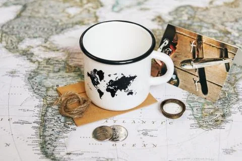 White mug with a map of the world on the background of the world map Stock Photos