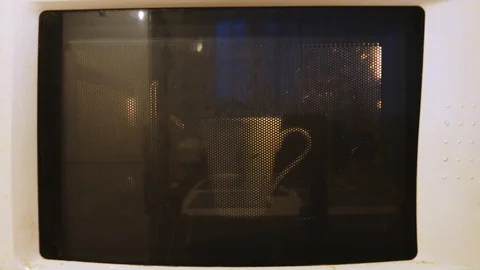 White mug in a microwave Stock Footage 100759420