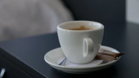 A white mug with a saucer containing aromatic coffee, topped with brown sugar Stock Footage 322183705