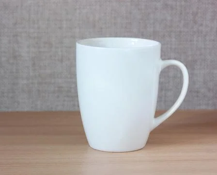 White mug on the table. Stock Photos