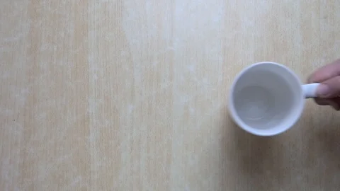 In a white mug on the table poured coffee and sugar Stock Footage 85820136