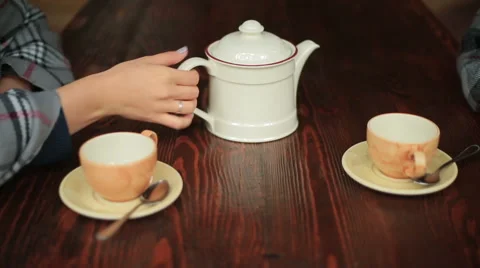 White mug of tea in hand on background of table Video stock 54693732