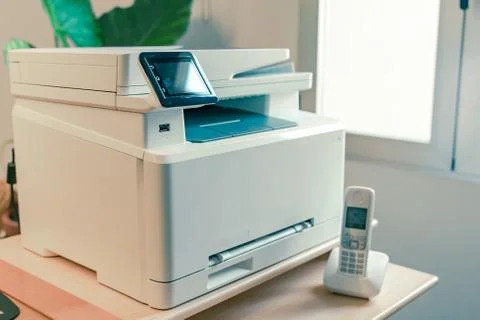 White Multi function color laser printer and wireless phone terminal. Stock Photos